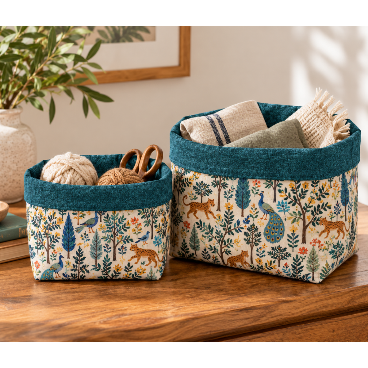 Set of two sewn fabric holders containing falls of yarn, hand towels, and scissors.