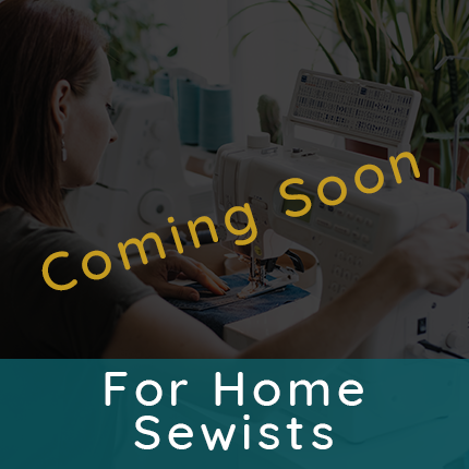 Woman sitting at a sewing machine stitching fabric for clothing representing tutorials for home sewists are coming soon
