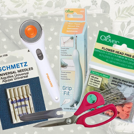 Image showing a collection of needles, pins, scissors, seam riper, and rotary cutter for available notion items.