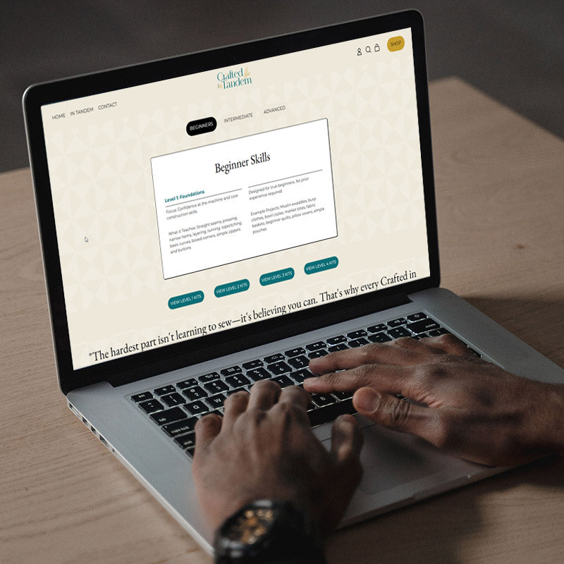 Person with their hands on a laptop keyboard looking at the skills section of the Crafted in Tandem website.